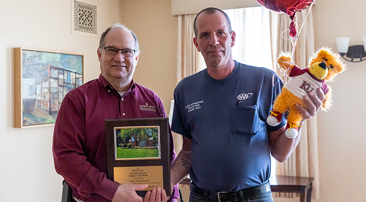 Newhard accepting award plaque from Hawkinson.